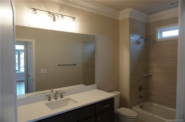 full bathroom with ornamental molding, toilet, vanity, and tiled shower / bath