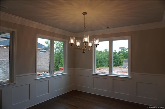 unfurnished dining area with plenty of natural light, dark hardwood / wood-style floors, and a chandelier