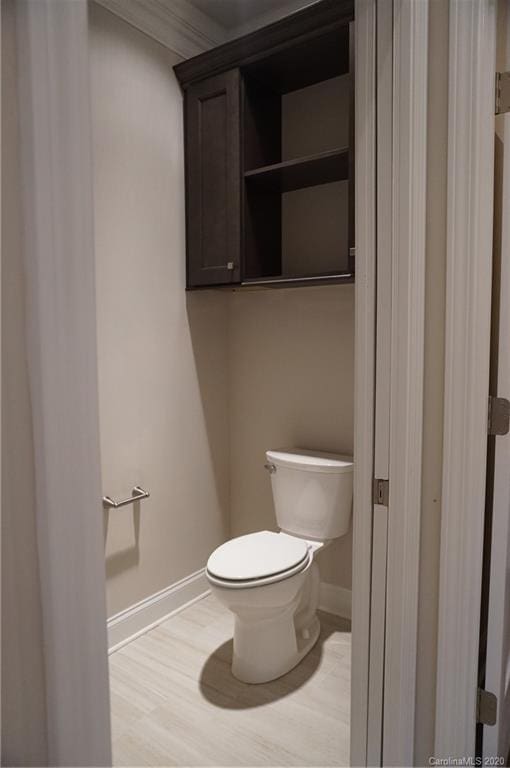 bathroom with hardwood / wood-style flooring and toilet