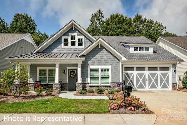 craftsman house with a porch and a garage