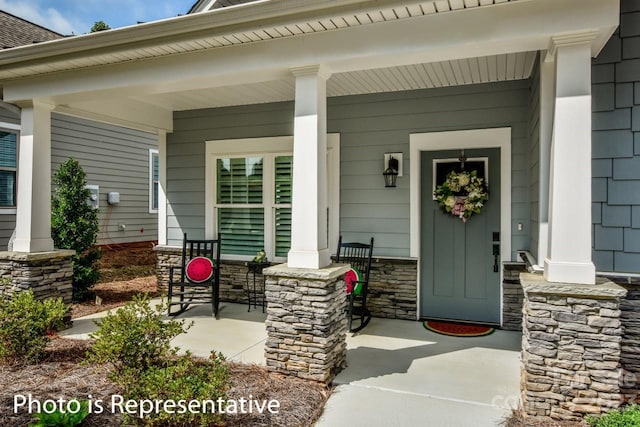 view of exterior entry with covered porch