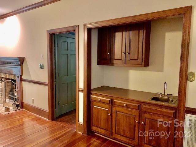 bar with sink and dark hardwood / wood-style flooring