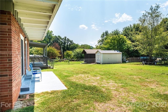 view of yard with a shed and a patio area