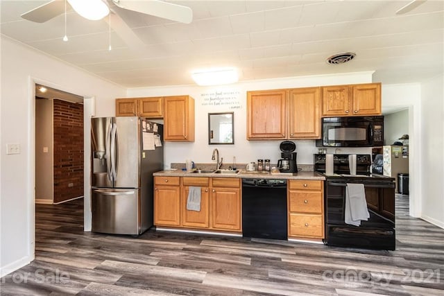 kitchen with brick wall, sink, ceiling fan, dark hardwood / wood-style flooring, and black appliances