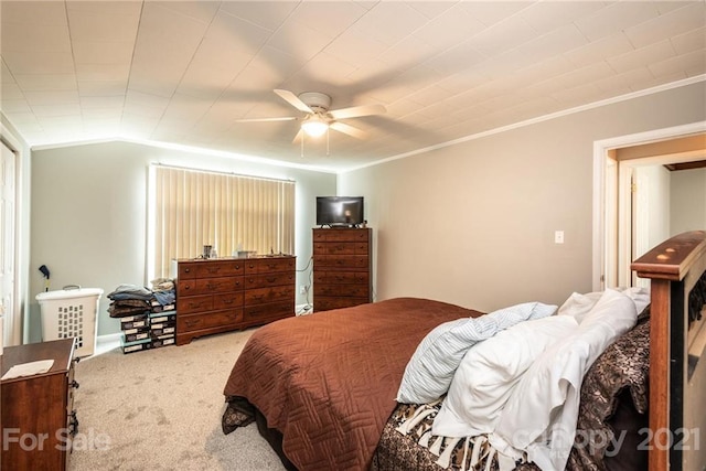 carpeted bedroom with ceiling fan and vaulted ceiling