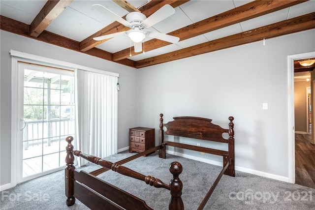 bedroom with dark carpet, ceiling fan, and beamed ceiling