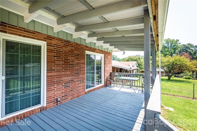 wooden terrace with a yard