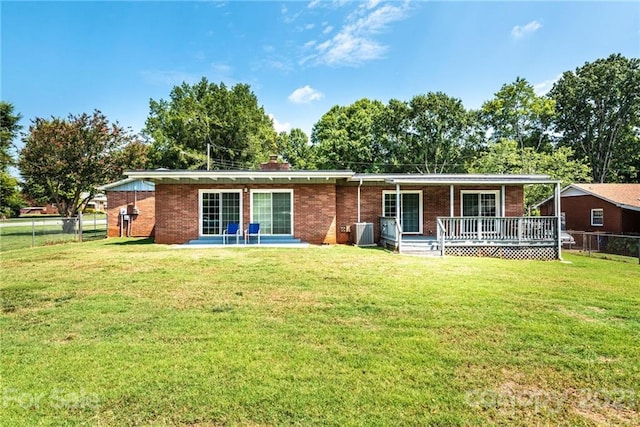 rear view of house featuring a patio and a lawn