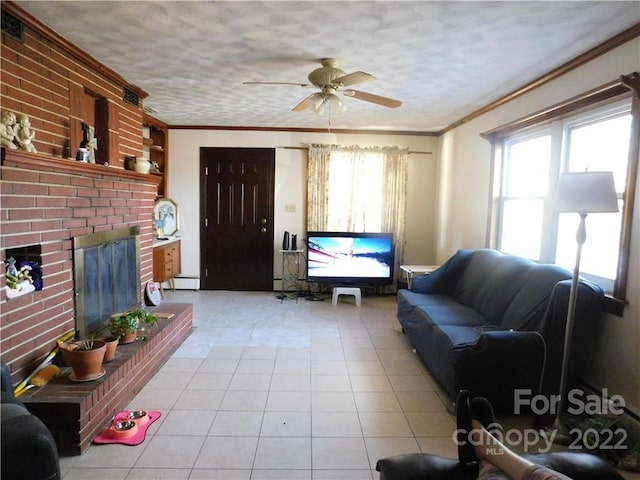 living room with light tile floors, ornamental molding, ceiling fan, and a fireplace