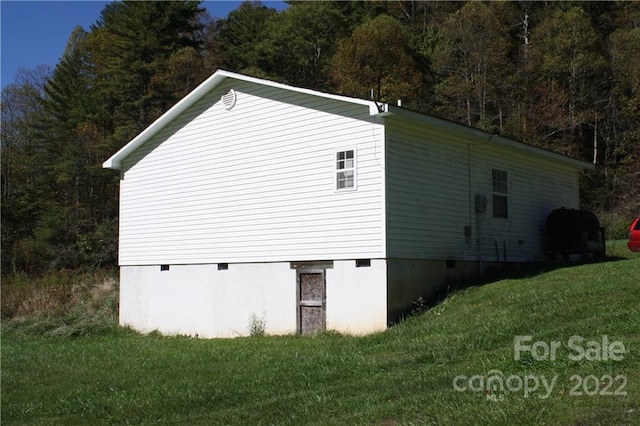 view of property exterior featuring a lawn