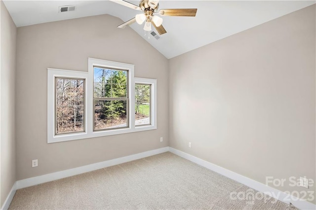 carpeted empty room with vaulted ceiling and ceiling fan