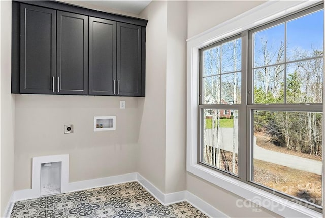 laundry area featuring cabinets, electric dryer hookup, washer hookup, and light tile floors