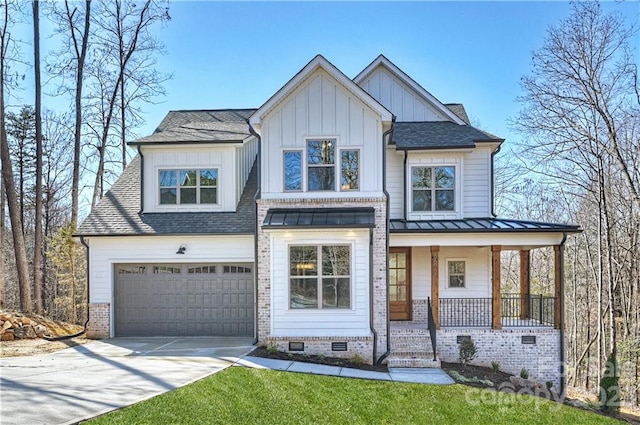 view of front of property with covered porch and a garage