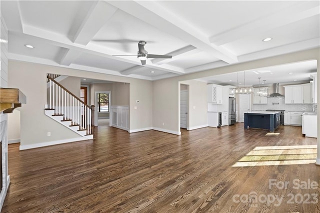 unfurnished living room featuring dark hardwood / wood-style flooring, ceiling fan, coffered ceiling, and beamed ceiling