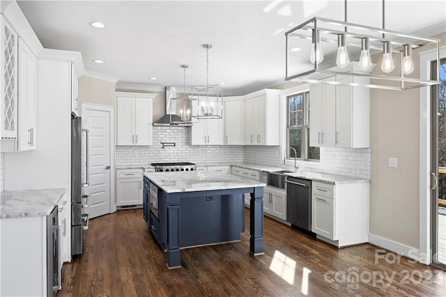 kitchen with wall chimney range hood, dark hardwood / wood-style flooring, pendant lighting, and white cabinets