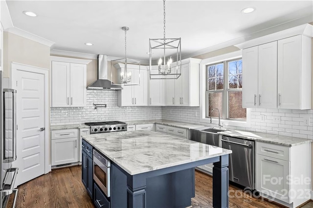 kitchen with pendant lighting, light stone counters, dark hardwood / wood-style flooring, white cabinets, and wall chimney exhaust hood