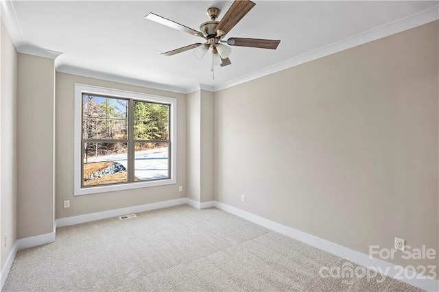 carpeted empty room featuring ceiling fan and ornamental molding