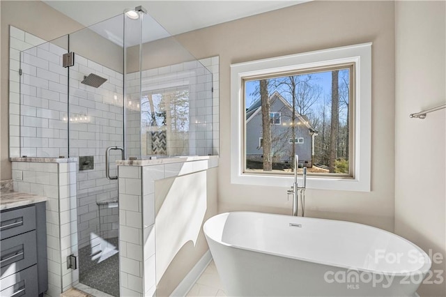 bathroom featuring separate shower and tub, tile flooring, and vanity