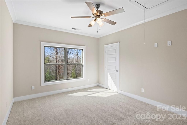 empty room featuring ceiling fan, crown molding, and light carpet