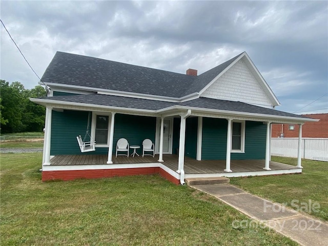 farmhouse-style home with a front yard and a porch