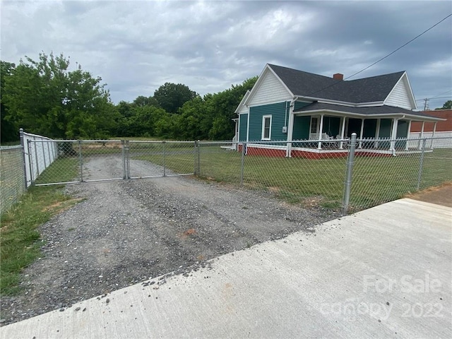 exterior space featuring covered porch and a lawn