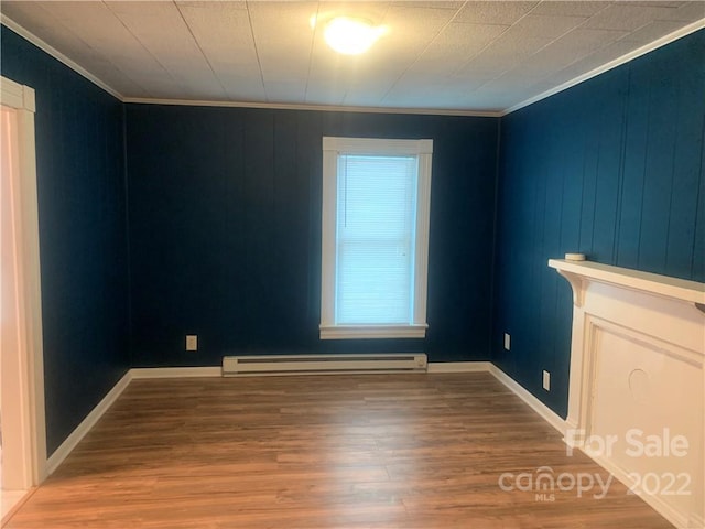 interior space featuring a baseboard radiator, ornamental molding, and light wood-type flooring