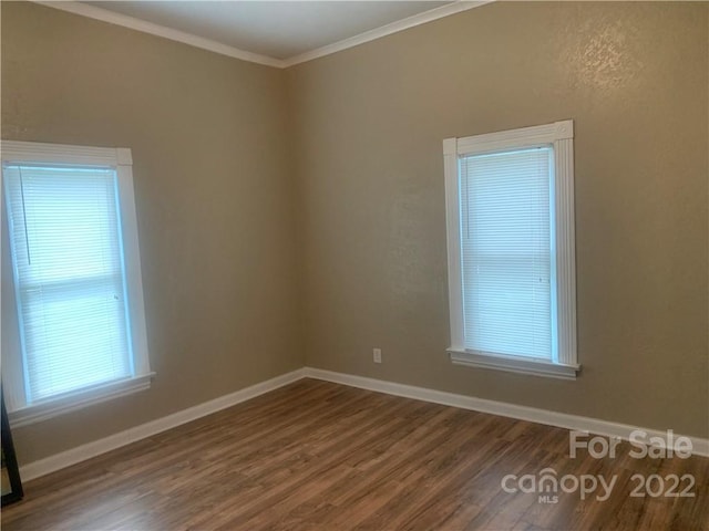 unfurnished room featuring dark hardwood / wood-style floors and crown molding