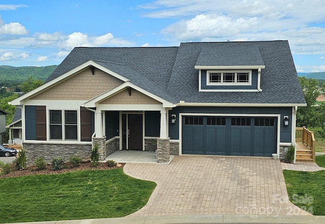 craftsman-style home featuring a front yard and a garage