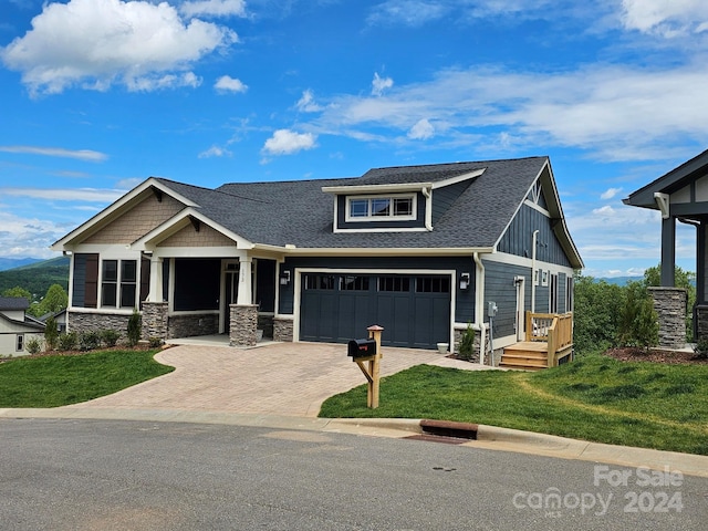 craftsman house featuring a front lawn and a garage