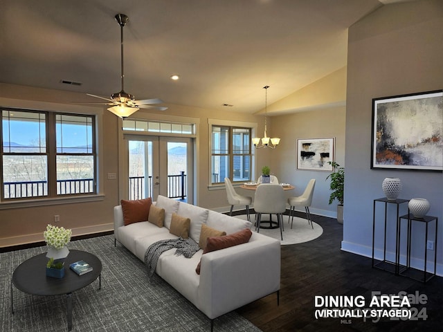 living room with dark hardwood / wood-style flooring, french doors, lofted ceiling, and ceiling fan with notable chandelier