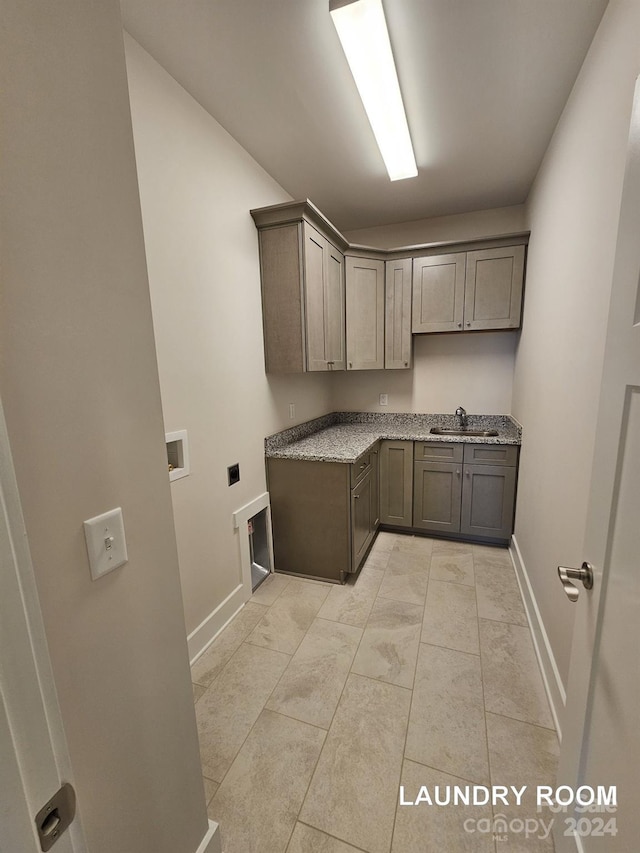 washroom with sink, cabinets, and washer hookup