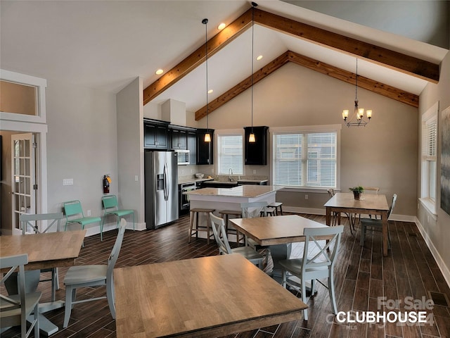 dining room with high vaulted ceiling, a notable chandelier, beamed ceiling, and sink