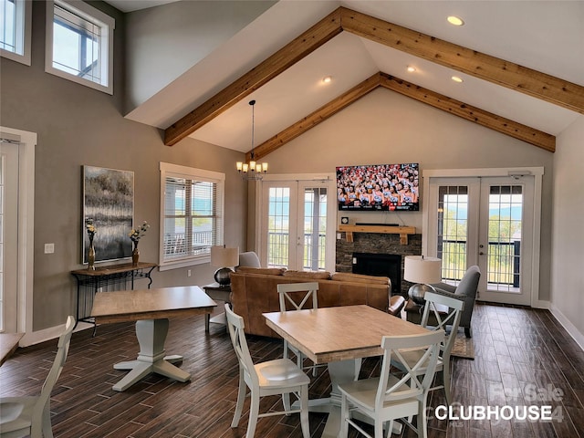 dining room featuring french doors, a high ceiling, a fireplace, and a notable chandelier