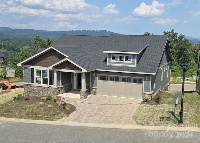 view of front of home featuring a garage and a mountain view