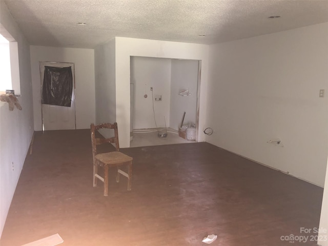 spare room with a textured ceiling