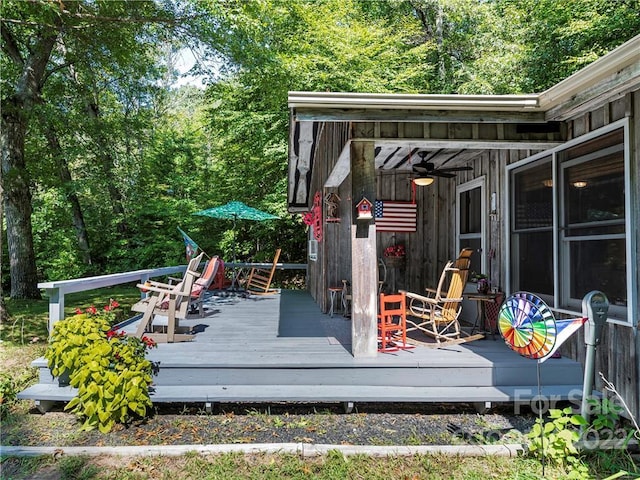 wooden terrace featuring ceiling fan