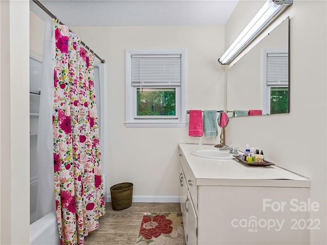 bathroom with vanity, hardwood / wood-style flooring, and shower / bathtub combination with curtain