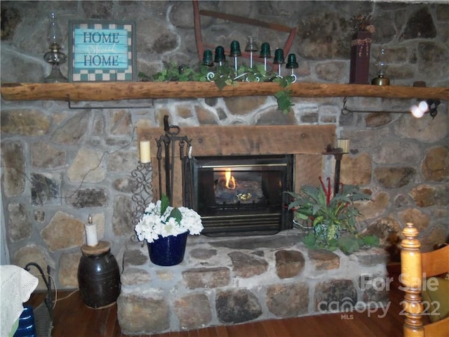 room details with a fireplace and hardwood / wood-style flooring