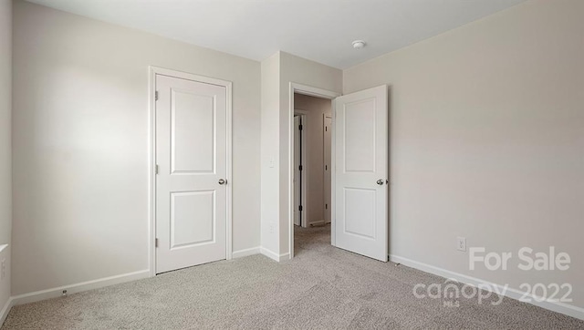 unfurnished bedroom with light colored carpet