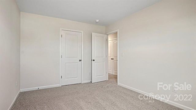 unfurnished bedroom with light carpet