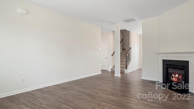 unfurnished living room with dark hardwood / wood-style floors