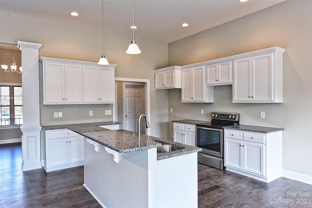 kitchen with pendant lighting, electric range, white cabinetry, and dark hardwood / wood-style flooring