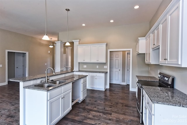 kitchen featuring sink, white cabinets, a center island with sink, and electric range