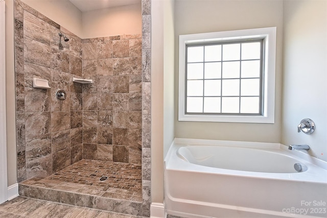 bathroom featuring separate shower and tub