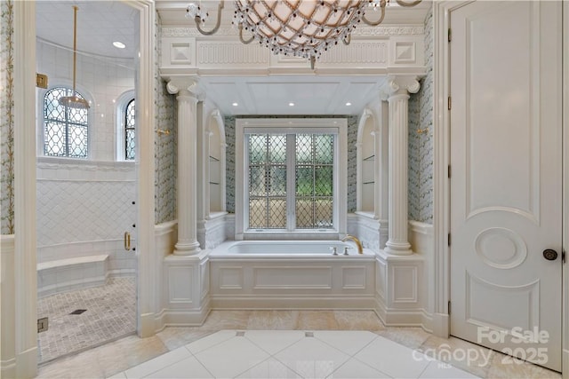 bathroom featuring ornate columns, shower with separate bathtub, tile patterned floors, and an inviting chandelier