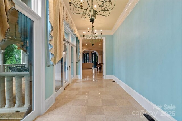 18019 Harbor Light Blvd, Cornelius, NC 28031 - hall featuring a chandelier, french doors, crown molding, arched walkways, and baseboards