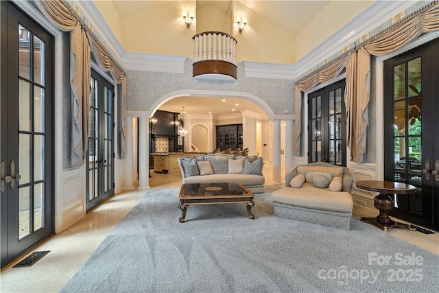 18019 Harbor Light Blvd, Cornelius, NC 28031 - living room with french doors, arched walkways, high vaulted ceiling, ornamental molding, and decorative columns