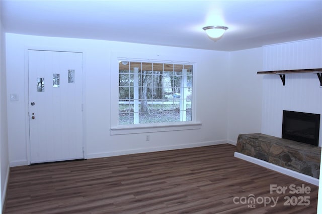 4 Morgan Cove Rd, Candler, NC 28715 - unfurnished living room with baseboards, dark wood-type flooring, and a stone fireplace