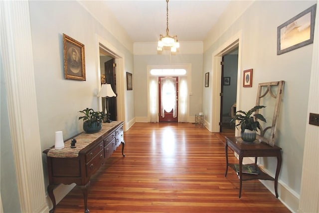 entrance foyer featuring an inviting chandelier and dark hardwood / wood-style floors