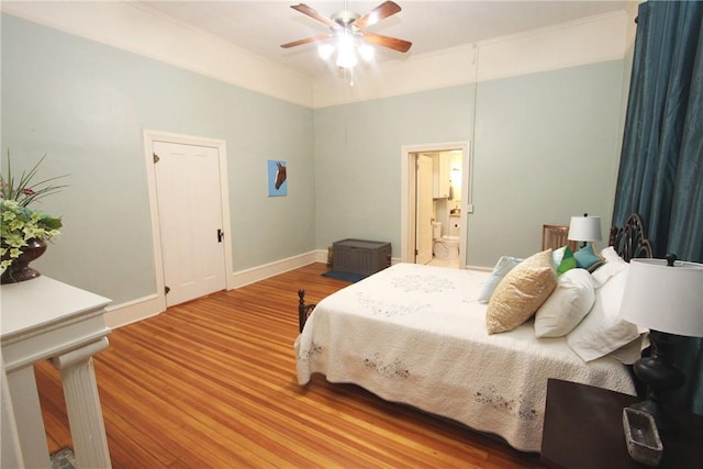 bedroom featuring ensuite bath, light hardwood / wood-style floors, and ceiling fan